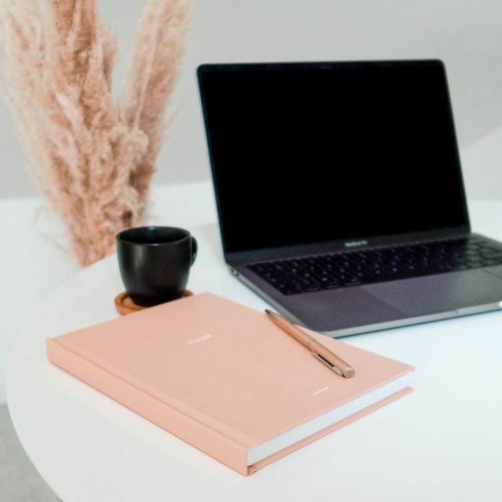 desk with notebook and computer